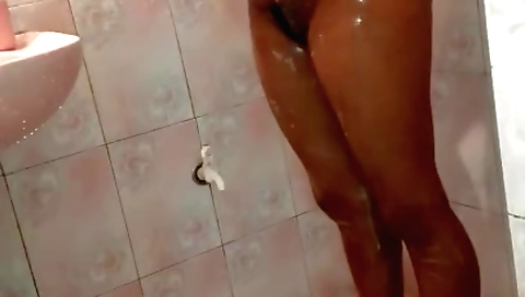 Stunning brunette takes off her clothes in the shower