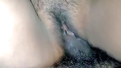 Indian woman masturbates with a dildo in her hairy pussy