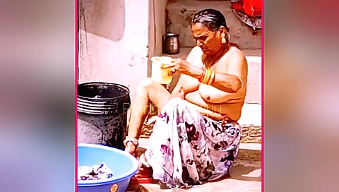 Indian granny shows her big tits and fat ass in the kitchen