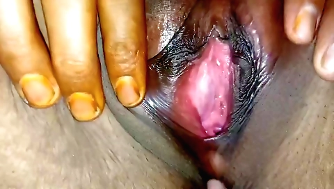 Hot girl with a tattooed face is fingering her pussy